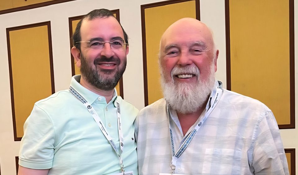 Aaron Lerch standing with Dr Leslie Greenberg